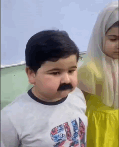 Boy With Fake Mustache and Girl in Yellow Dress