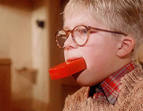 Boy With Glasses Eating Red Bar