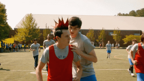 Boy With Red Mohawk in Grey Shirt Saying Get High
