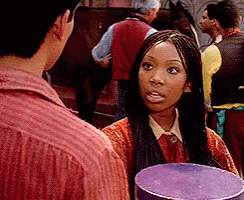 Braided Woman Holding Purple Box Talking To Man GIF