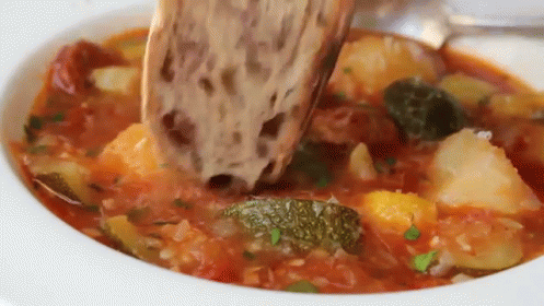 Bread Dipping Into Soup