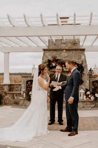 Bride and Groom Getting Married by Stone Fireplace