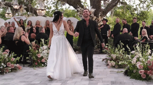 Bride and Groom Holding Hands Down Aisle