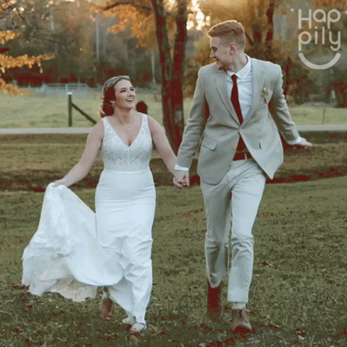 Bride and Groom Holding Hands in Field