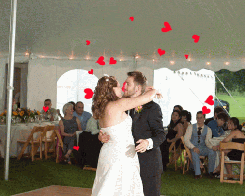 Bride and Groom Kissing Under White Tent