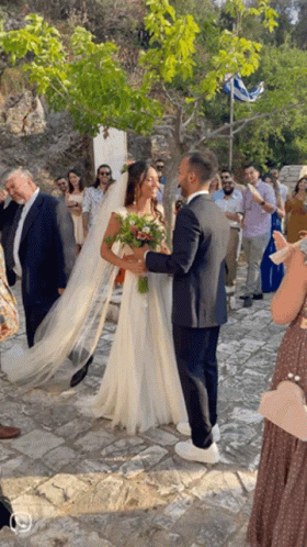 Bride and Groom Posing in Front of Crowd