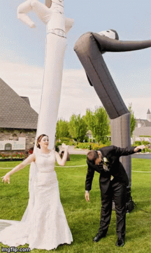 Bride and Groom Posing With Large Inflatable Man