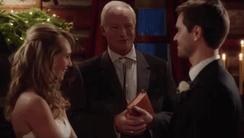 Bride And Groom Smiling At Wedding With Priest Holding Bible GIF