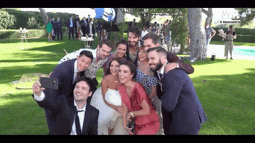 Bride and Groom Taking Selfie With Group