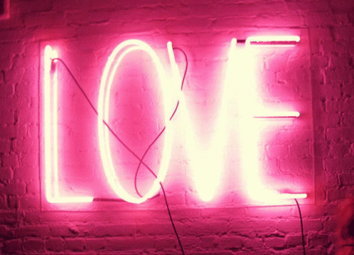 Bright Pink Neon Sign Saying Love On Brick Wall GIF