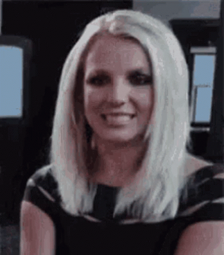 Britney Spears Is Smiling And Wearing A Black Dress . GIF