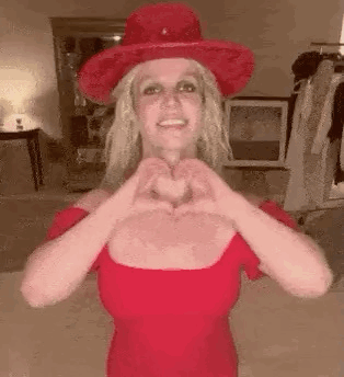 Britney Spears Making Heart Shape In Red Dress And Red Hat GIF
