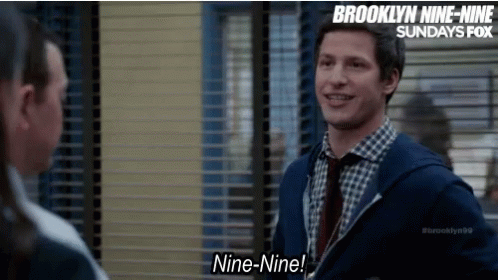 Brooklyn Nine-Nine Man Smiling Talking to Another Man