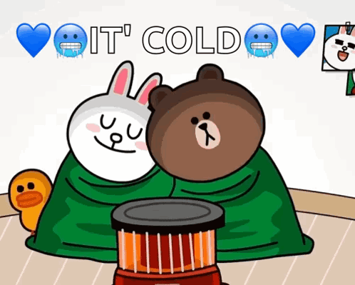 Brown Bear And White Rabbit Wrapped In Green Blanket Next To Heater GIF