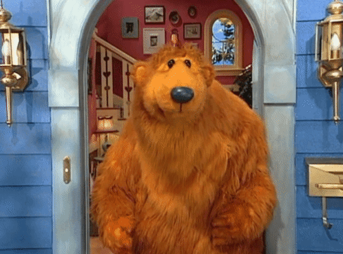 Brown Teddy Bear With Blue Nose Standing In Doorway GIF
