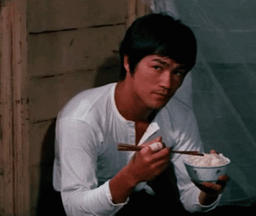 Bruce Lee Eating Rice With Chopsticks GIF
