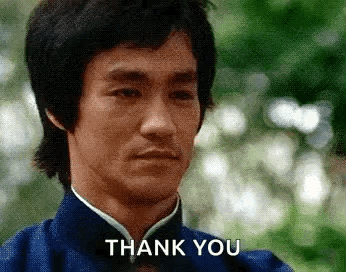 Bruce Lee In Blue Shirt And Bow Tie Saying Thank You GIF