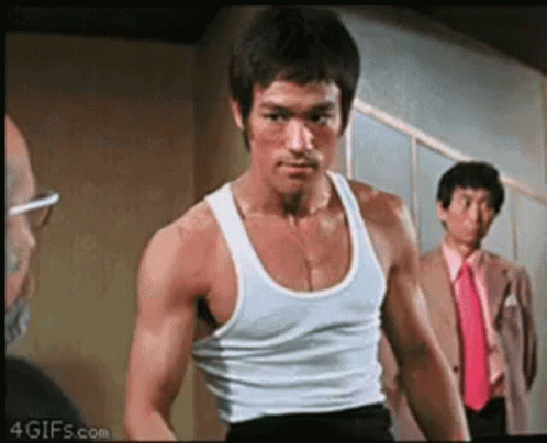 Bruce Lee in White Tank Top and Black Shorts