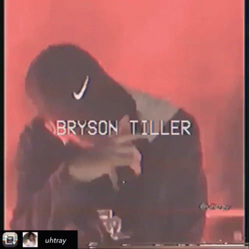 Bryson Tiller in Black Hat With White Nike Logo