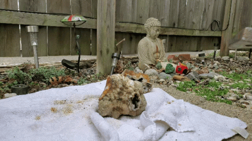 Buddha Statue Sitting On Towel GIF