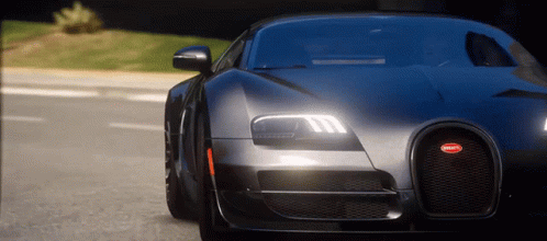 Bugatti Driving Down Street at Night