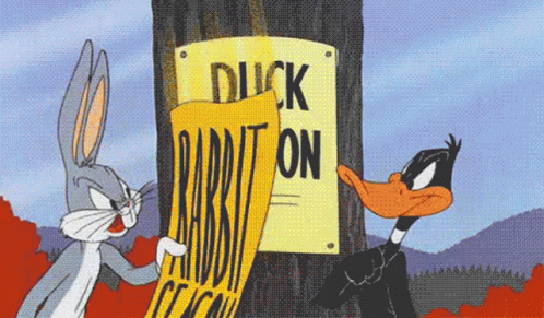 Bugs Bunny and Daffy Duck Standing Next to Duck on Rabbit Sign