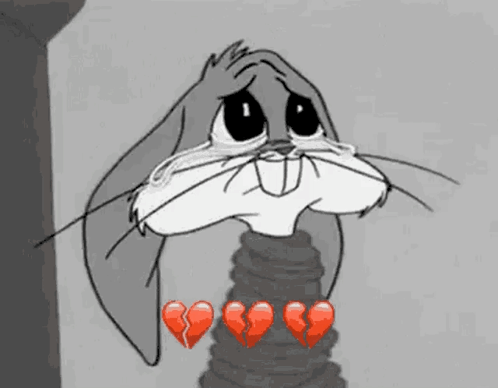 Bugs Bunny From Looney Tunes Is Crying With Broken Hearts Around Him . GIF