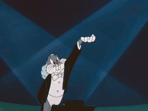 Bugs Bunny Is Wearing A Tuxedo And Bow Tie And Raising His Hand GIF