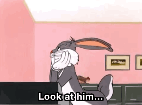 Bugs Bunny On Pink Wall With Look At Him Sign GIF