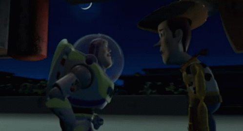 buzz lightyear and woody from toy story are standing next to each other at night