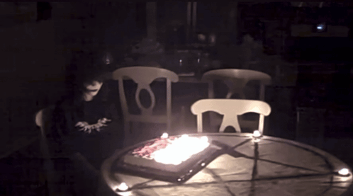 Cake With Candles On Table in Dark