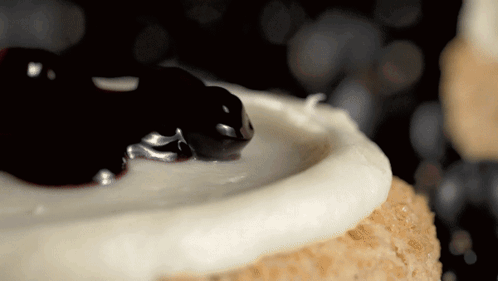 Cake with White Frosting and Blueberry Sauce