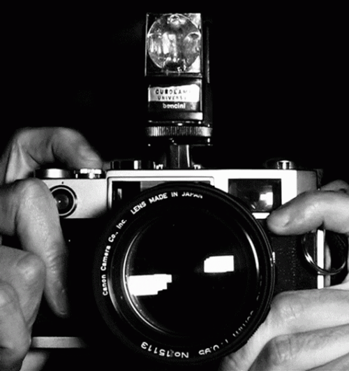 Camera flash black and white gif.