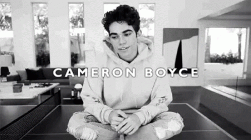 Cameron Boyce Sitting on Ping Pong Table