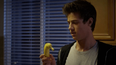 Cameron Dallas Holding And Spinning Banana GIF