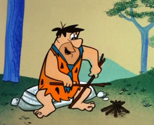 Fred Flintstones Making Campfire GIF