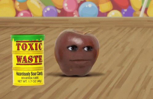 Can of Toxic Waste Next to Apple on Wooden Table