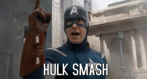 Captain America Is Pointing Up And Saying `` Hulk Smash '' While Wearing A Mask And Gloves . GIF