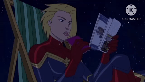 Captain Marvel Sitting in Chair Reading Book