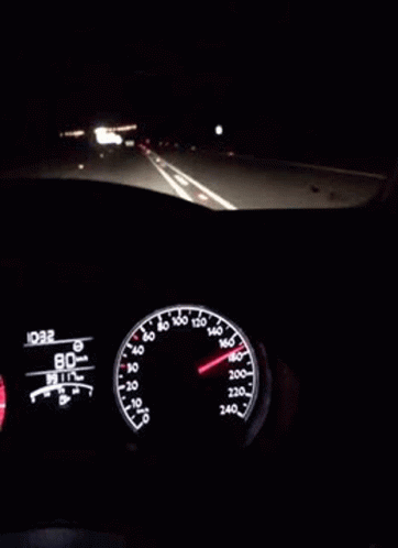 Car Dashboard Lit Up at Night