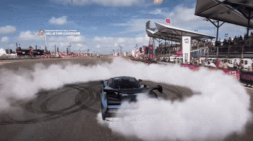 Car Drifting on Track with Hall of Fame Sign