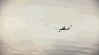 Car Driving Along Curvy Ocean Road GIF