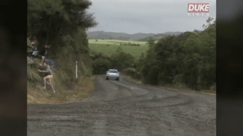 Car Driving Down Dirt Road