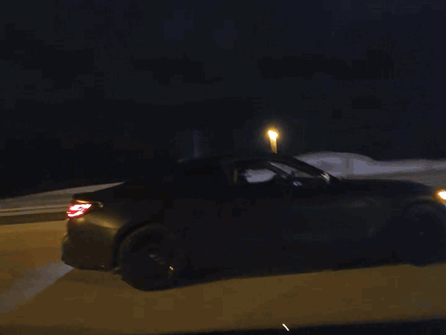 Car Driving Down Road At Night GIF