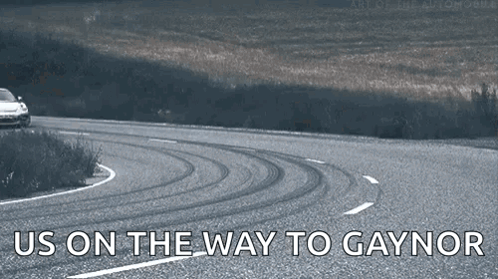 Car Driving Down Road Saying Us on the Way to Gaynor