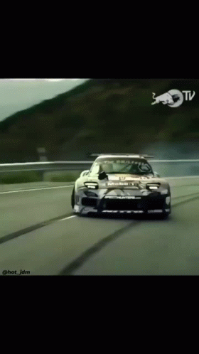 Car Driving Down Road With Red Bull Logo