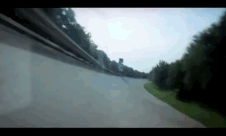 Car Driving Down Road With Trees