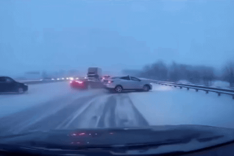 Car Driving Down Snowy Highway