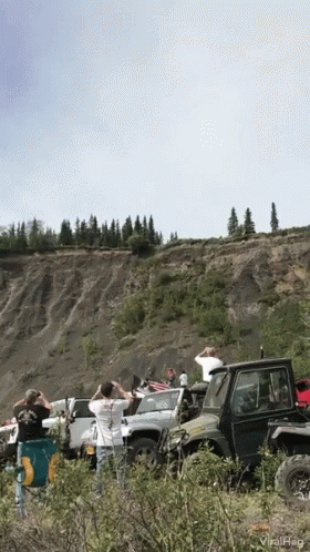 Car Driving Off Cliff With People Watching GIF
