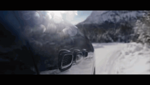 Car Driving on Snow Covered Road